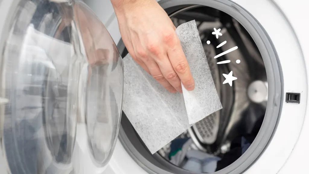 Close-up of a dryer with dryer sheets inside, symbolizing how dryer sheets can cause hidden damage to the appliance