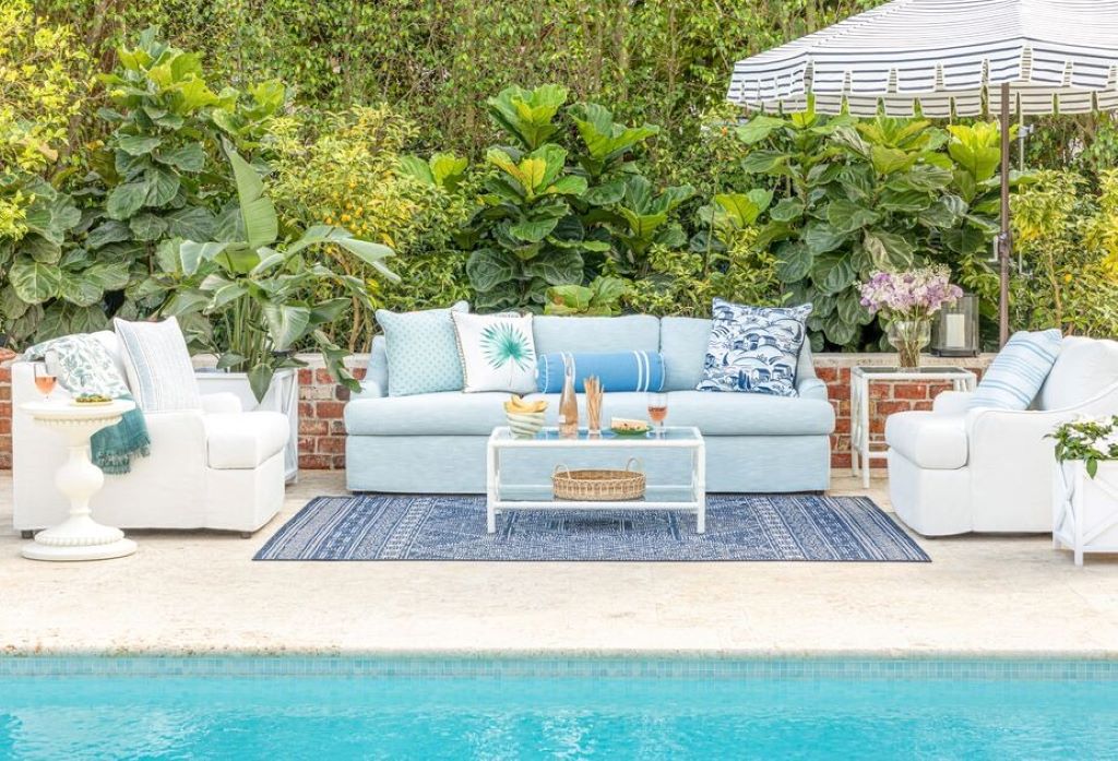 A spacious outdoor screen room with furniture, illustrating ideal layouts and sizes for a comfortable living space