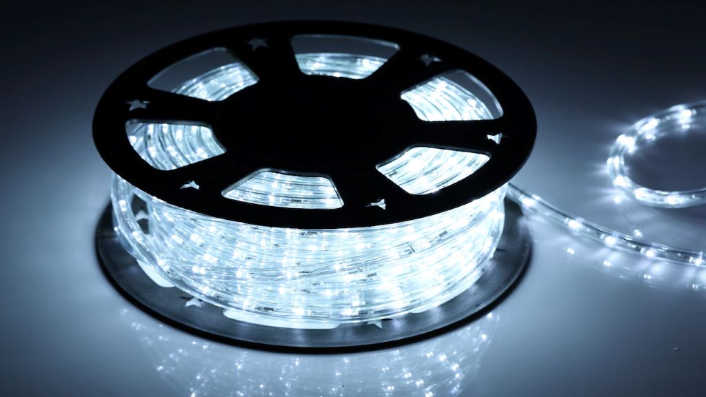 100ft waterproof rope light glowing warm white against a rainy patio backdrop